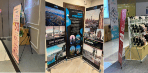 Khác Nhau Giữa Standee Cuốn Nhôm Và Standee Chân X | Nên Mua Loại Nào?